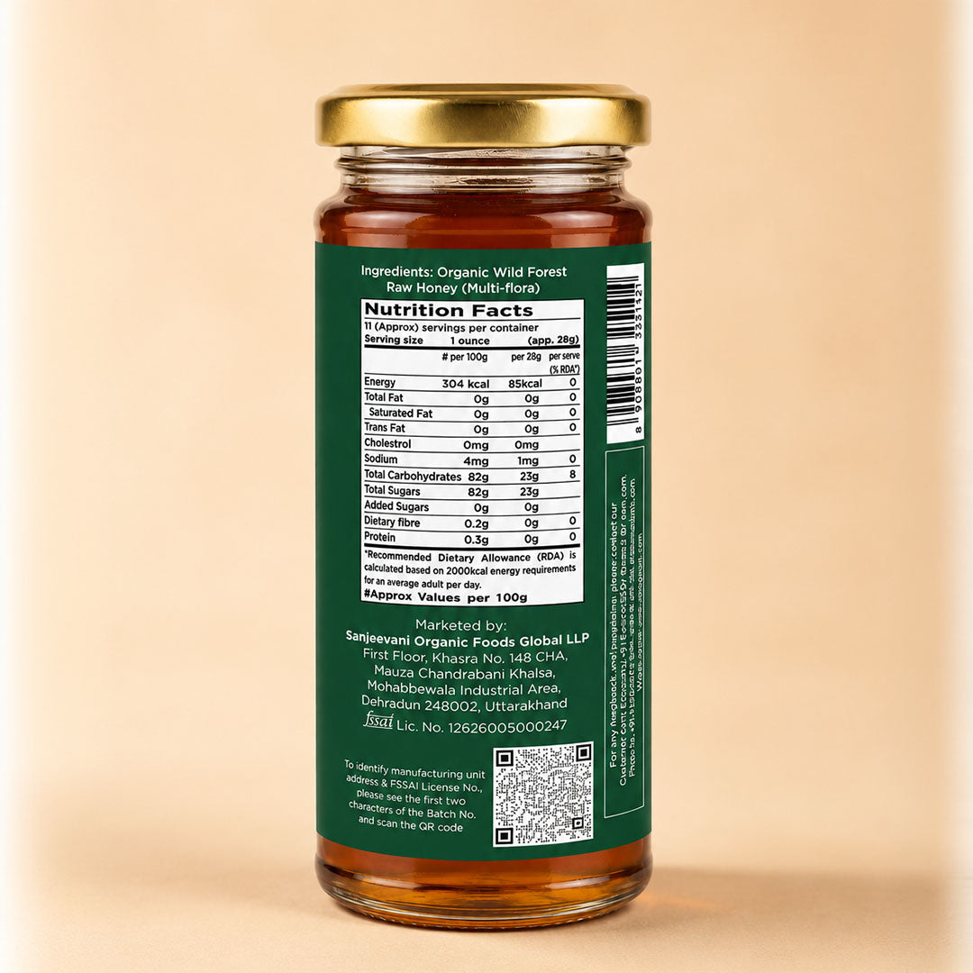 Barsana Magic and A glass jar of raw honey with a gold metal lid and a dark green label showing the nutrition facts, set against a solid beige background.