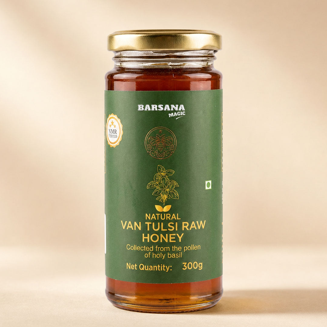 Barsana Magic and A 300g glass jar of Barsana Magic Natural Van Tulsi Raw Honey with a gold lid and a dark green label, set against a warm beige background.