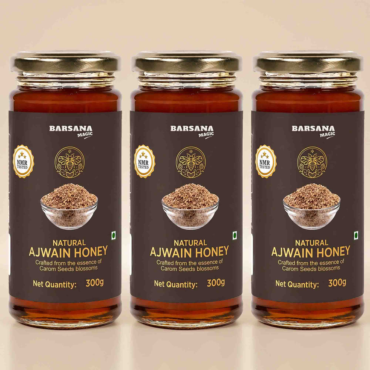 Barsana Magic and Three glass jars of Barsana Natural Ajwain Honey arranged side by side on a light beige background. Each jar has a dark brown label with gold lettering, a photo of ajwain seeds in a bowl, and a gold cap.