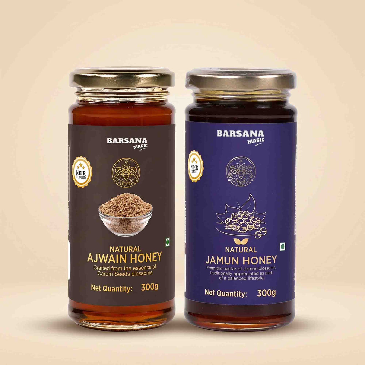 Barsana Magic and Two glass jars of Barsana Spices honey on a beige background. The left jar is labeled 'Natural Ajwain Honey' with a dark brown label, and the right jar is labeled 'Natural Jamun Honey' with a deep purple label.