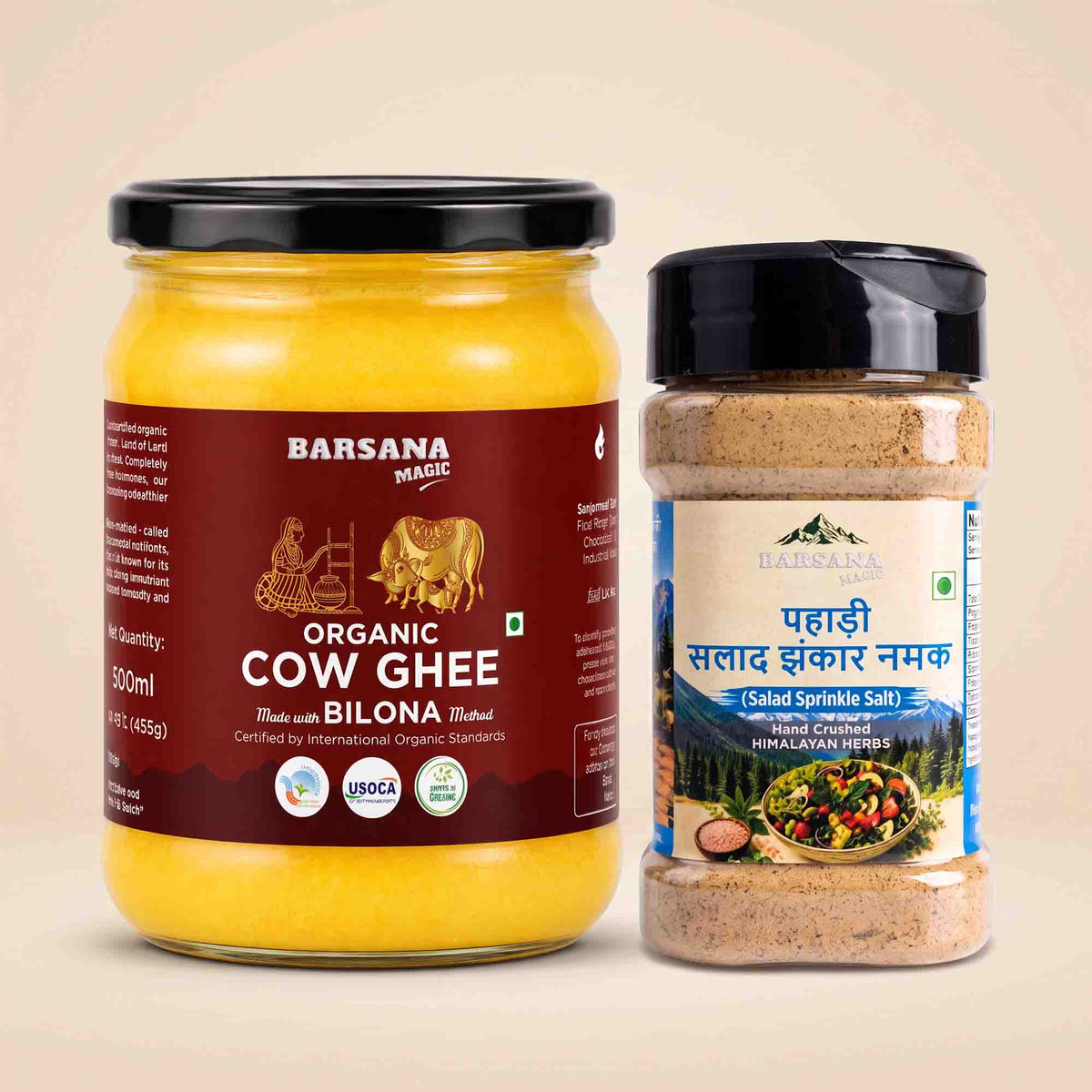 Barsana Magic and A 500ml glass jar of Barsana Magic Organic Cow Ghee next to a plastic shaker bottle of Barsana Magic Salad Spinkle Masal, both with black lids, set against a solid beige background.