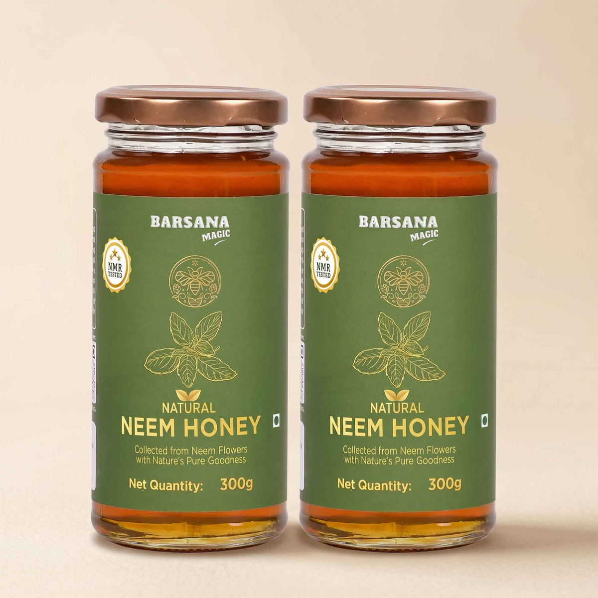 Barsana Magic and Two glass jars of Barsana Magic Natural Neem Honey with green labels and copper-colored lids, set against a solid beige background.