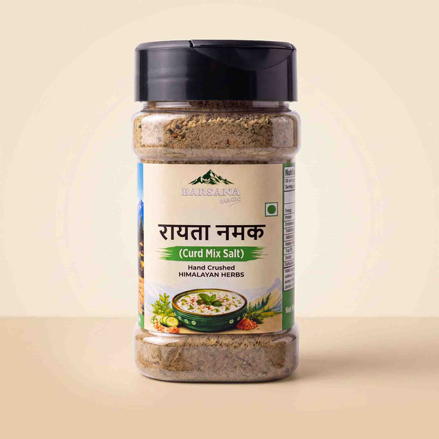 Barsana Magic and A bottle of Barsana Hand Crushed Curd Mir Salt (Himalayan Herbs) with a black lid and cream-colored label, set against a warm beige background.