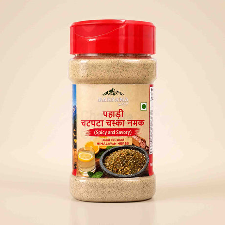 Barsana Magic and A bottle of Baisakhi Hand Crushed Chotki Chashni Namak (spicy and savory Himalayan herbs) with a red cap and a beige label, set against a light beige background.