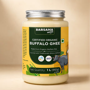 Barsana Magic and A 1-liter jar of Barsana Magic Certified Organic Buffalo Ghee, featuring a yellow label with a dark green central panel, a silver metal lid, and an illustration of a buffalo on a beige background.
