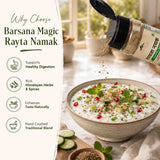 Barsana Magic and A bottle of Barsana Magic Rayta Namak spice blend is shown open with seasoning being sprinkled over a bowl of raita, alongside text listing benefits such as supports healthy digestion and rich Himalayan herbs & spices.
