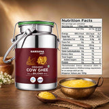 Barsana Magic and A large stainless steel canister of Barsana Organic Cow Ghee with a dark red label, shown on a wooden surface with bowls of yellow ghee and a nutrition facts panel displayed on the right.