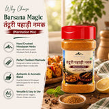 Barsana Magic and Tandoori Pahadi Namak (Marination Mix) in a clear plastic jar with a red lid, shown on a rustic wooden table with food props and a white informational panel on the left.