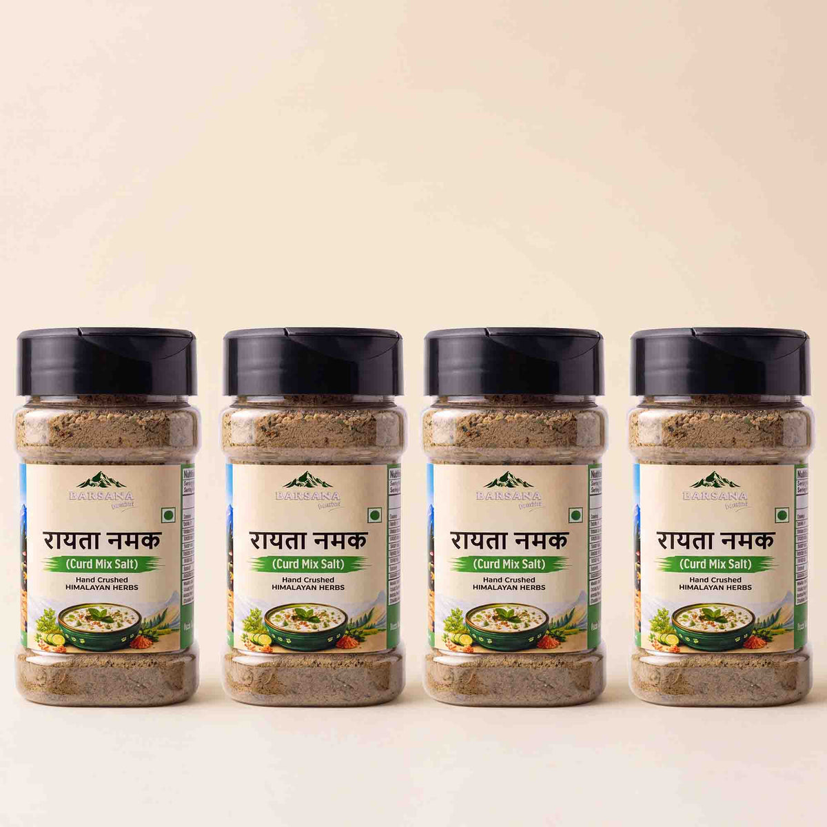 Barsana Magic and Four jars of Rawatna Namak (Coconut Coated Himalayan Pink Salt) arranged in a row against a light beige background. The clear plastic jars show the brownish salt inside, with white labels featuring green and black text, and black lids.