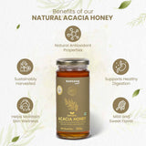 Barsana Magic and A 300g glass jar of Barsana Natural Acacia Honey centered on a light textured background with decorative leaves and informational icons around it, highlighting antioxidant, digestive, skin wellness, and mild sweet flavor benefits.