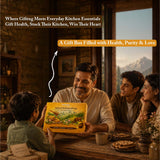 Barsana Magic and Family gathered around a table with a gift box, set against a mountainous landscape.