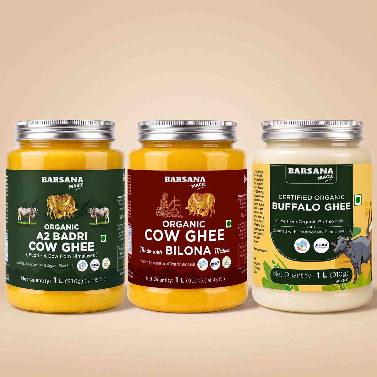 Barsana Magic and Three jars of Barsana Magic brand ghee arranged side by side on a warm beige background. The left jar is Organic A2 Badri Cow Ghee with a dark green label; the middle jar is Organic Cow Ghee made with Bilona butter, with a dark red label; the right jar is Certified Organic Buffalo Ghee with a yellow and green label.