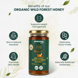 Barsana Magic and A jar of Barsana Magic Organic Wild Forest Honey centered on a light textured background with decorative leaves. Surrounding text highlights benefits such as weight management, natural nutrients, skin health, and balanced sweetness.