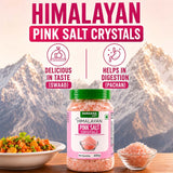 Barsana Magic and A jar of Barsana Himalayan Pink Salt Crystals displayed on a wooden surface with a bowl of mixed vegetables and a small glass bowl of salt, set against a mountain backdrop. The image includes marketing text highlighting taste and digestion benefits.