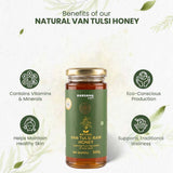 Barsana Magic and A jar of Barsana Natural Van Tulsi Raw Honey centered on a light off-white background with decorative leaves and text highlighting benefits such as vitamins, minerals, healthy skin, and traditional wellness. The jar has a dark green label and a gold metal lid.