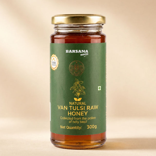 Barsana Magic and A 300g glass jar of Barsana Magic Natural Van Tulsi Raw Honey with a gold lid and a dark green label, set against a warm beige background.