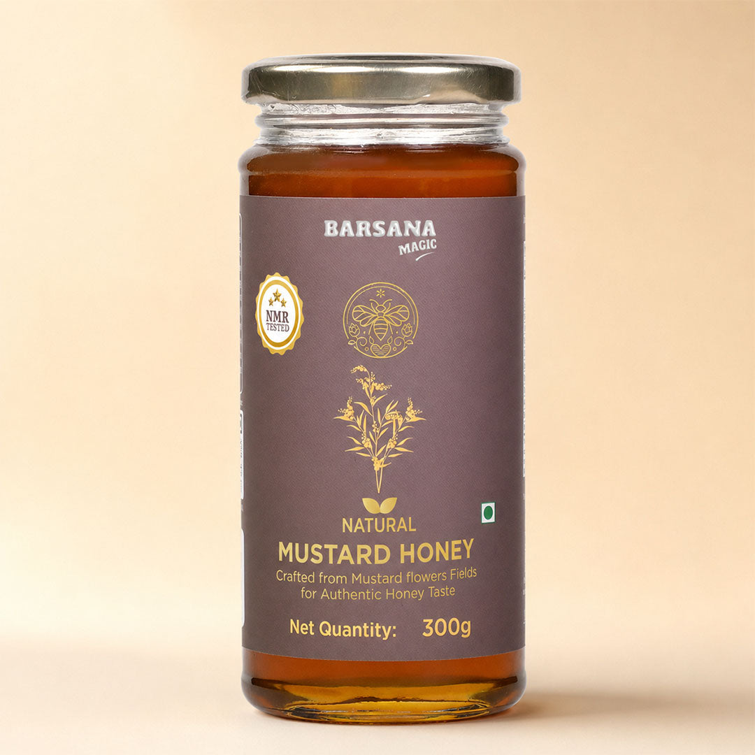 Barsana Magic and A 300g glass jar of Barsana Magic Natural Mustard Honey, featuring a dark brown label with gold lettering and illustrations, topped with a silver metal lid, set against a solid beige background.