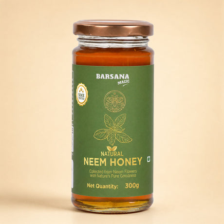 Barsana Magic and A 300g glass jar of Barsana Magic Natural Neem Honey, featuring a dark green label with gold text and illustrations, topped with a metallic bronze lid, set against a solid beige background.