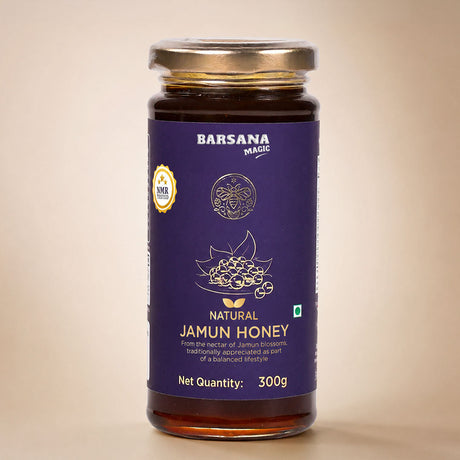 Barsana Magic and A 300g glass jar of Barsana Magic Natural Jamun Honey, featuring a deep purple label with gold and white text and graphics, topped with a metallic gold lid, set against a warm beige background.