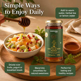 Barsana Magic and A jar of Barsana Natural Van Tulsi Raw Honey displayed on a wooden tray with a bowl of fruit salad, a honey dipper, and text overlays describing its daily use.