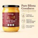 Barsana Magic and A jar of Barsana Magic Organic Cow Ghee on a light beige background with promotional text on the right. The jar has a black lid and a dark maroon label with white text and illustrations of a pot and an ox.