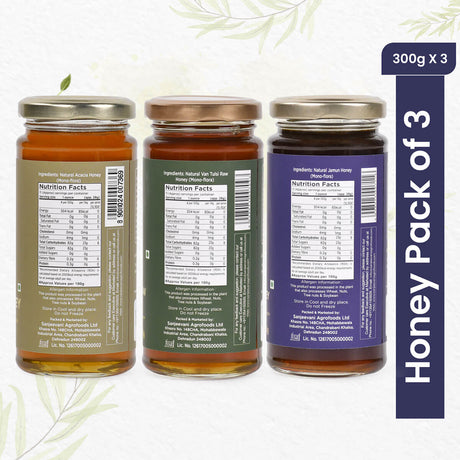 Trio of 100% natural honeys—Van Tulsi, Jamun, and Acacia—in glass jars, showcasing golden hues and pure, raw sweetness.