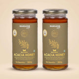 Barsana Magic and Two jars of Barsana Magic Natural Acacia Honey, 300g each, displayed side-by-side on a light beige background.