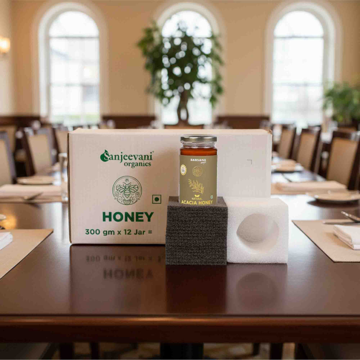 Barsana Magic and Jar of honey on a stand with a box labeled 'Sanjeevani Organics' in a room setting.