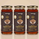 Barsana Magic and Three glass jars of Barsana Natural Ajwain Honey arranged side by side on a light beige background. Each jar has a dark brown label with gold lettering, a photo of ajwain seeds in a bowl, and a gold cap.