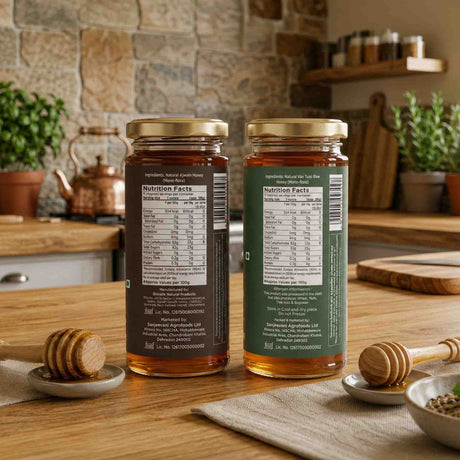 Barsana Magic and Two jars of honey with labels on a wooden table in a kitchen setting.