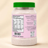 Barsana Magic and A plastic jar of Sanjeevani Organic Food Gujarat natural Himalayan salt, showing the back label with nutrition facts and contact details, topped with a green lid on a beige background.