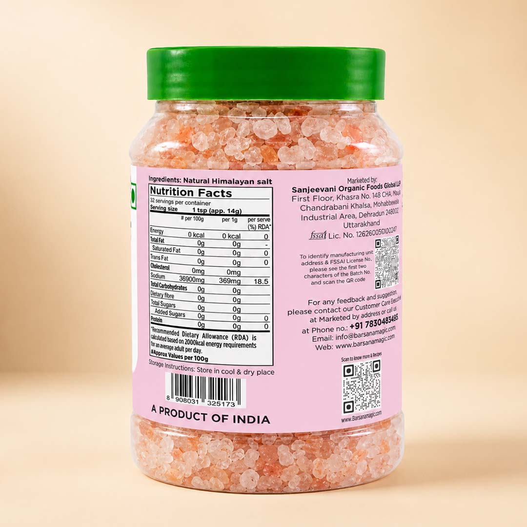 Barsana Magic and A jar of Himalayan salt with a green lid and a pink label showing the nutrition facts and product details, set against a warm beige background.