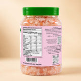 Barsana Magic and A jar of Himalayan salt with a green lid and a pink label showing the nutrition facts and product details, set against a warm beige background.