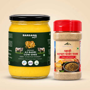 Barsana Magic and Two Barsana Magic spices and ghee products on a beige background: a large glass jar of organic Az Badri Cow Ghee with a black lid and dark green label, and a smaller clear plastic spice container with a red lid and cream label.