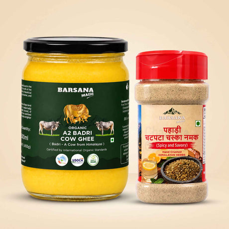 Barsana Magic and Two Barsana Magic spices and ghee products on a beige background: a large glass jar of organic Az Badri Cow Ghee with a black lid and dark green label, and a smaller clear plastic spice container with a red lid and cream label.