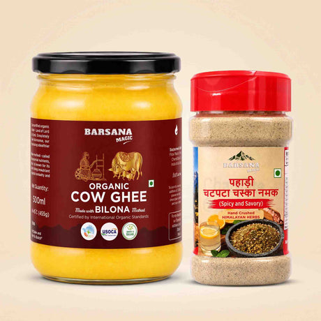 Barsana Magic and A jar of Barsana Magic Organic Cow Ghee and a plastic shaker of the same brand's Patli and Bilona (Spicy and Savory) spice mix, displayed side-by-side on a light beige background.