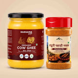 Barsana Magic and A jar of Barsana Magic Organic Cow Ghee next to a plastic bottle of Barsana Magic Taddri Pahadi Namak (marination mix) on a solid beige background.