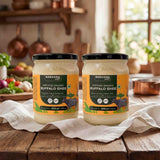 Barsana Magic and Two jars of Certified Organic Buffalo Ghee on a wooden table with a kitchen background.