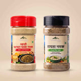 Barsana Magic and Two jars of Barmenara Maje spices on a light beige background: a red-capped Hand Crumbled Himalayan Salt jar on the left and a black-capped Hand Countered Himalayan Herbs jar on the right.