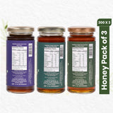 Barsana Magic and Three jars of honey with labels on a white background