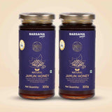 Barsana Magic and Two 300g glass jars of Barsana Magic Natural Jamun Honey, featuring dark purple labels with gold foil details and silver metal lids, set against a light beige background.