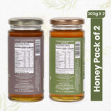 Two jars of 100% Natural Mustard Honey and Neem Honey side by side, showcasing their rich, golden and amber hues.
