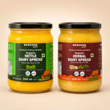 Barsana Magic and Two 500 ml jars of Barsana Organic spreads on a light beige background. The left jar contains Organic Nettle Dairy Spread with a green label, and the right jar contains Organic Herbal Dairy Spread with a dark red label.