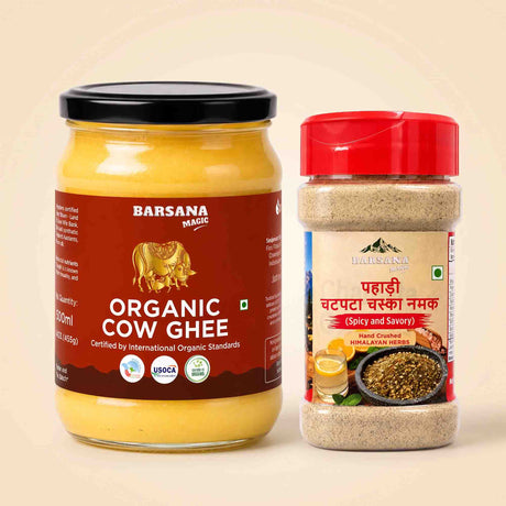 Barsana Magic and Two Barsana Magic products on a light beige background: a large glass jar of Organic Cow Ghee with a black lid and brown label, and a smaller clear plastic spice container with a red lid and beige label.