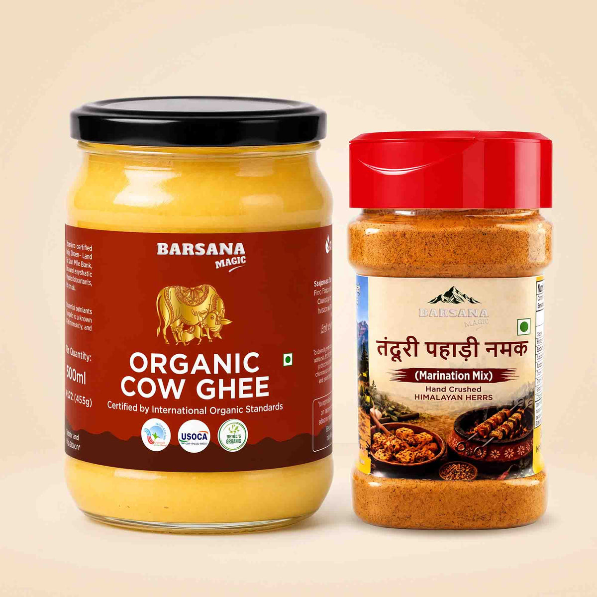 Barsana Magic and A glass jar of Barsana Magic Organic Cow Ghee with a black lid and a brown label, next to a plastic bottle of Barsana Magic Tendu Pahaade Namak (Himalayan Marination Mix) with a red lid, set against a solid beige background.