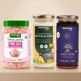 Barsana Magic and Three Barsana Magic products displayed side-by-side on a light beige shelf: a jar of Himalayan Pink Salt Crystals with a green lid, a glass jar of Certified Organic Buffalo Ghee with a gold lid, and a dark glass jar of Natural Jamun Honey with a purple lid.