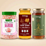 Barsana Magic and Three Barsana Magic products displayed side-by-side on a light beige background: Himalayan Pink Salt Crystals in a clear jar with a green lid, Organic Cow Ghee in a yellow jar with a gold lid, and Natural Van Tulsi Raw Honey in a dark green jar with a gold lid.