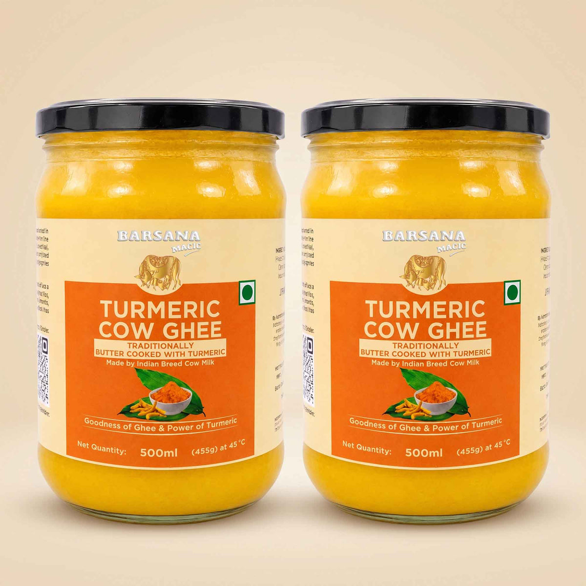 Barsana Magic and Two 500ml glass jars of Barsana Organic Turmeric Cow Ghee side by side on a light beige background. The jars contain a bright yellow-orange ghee and are fitted with black lids, featuring cream and orange labels with product details.