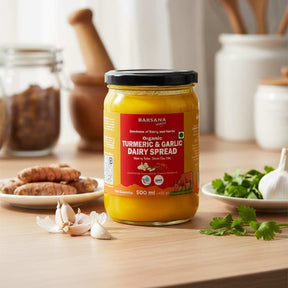 Barsana Magic and Jar of Turmeric & Garlic Dairy Spread on a wooden table with ingredients in the background