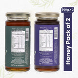Two jars of Organic Wild Forest Honey and Natural Jamun Honey, showcasing pure, golden sweetness from India's forests.